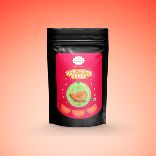 Black pouch of Namaste Honey Amla Candy, 200g, on a coral background.